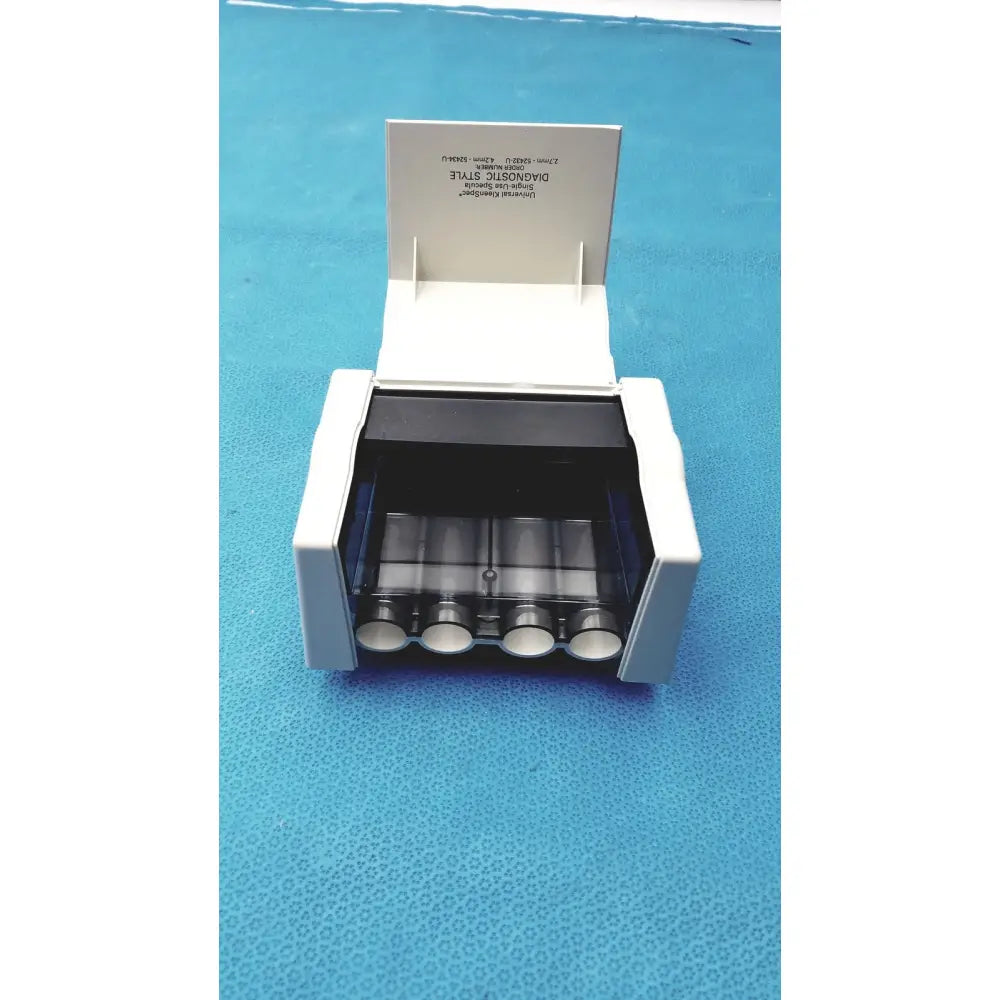 Welch Allyn Universal KleenSpec single use specula dispenser in white plastic with four transparent cylindrical compartments