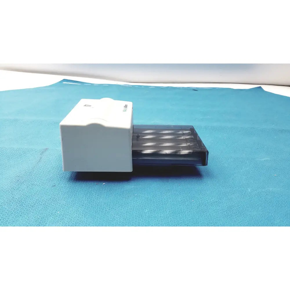 White plastic box with transparent drawer holding multiple cylindrical objects for welch allyn universal kleenspec single use specula dispenser