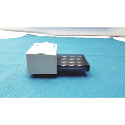 White plastic box with transparent drawer holding multiple cylindrical objects for welch allyn universal kleenspec single use specula dispenser