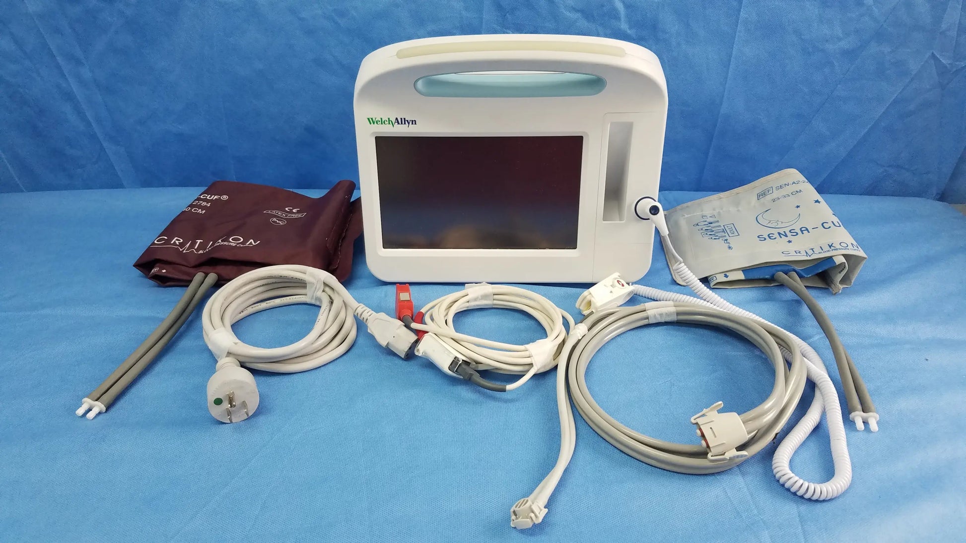 White welch allyn vital signs monitor 6000 series with rectangular screen, integrated handle, and blood pressure cuffs