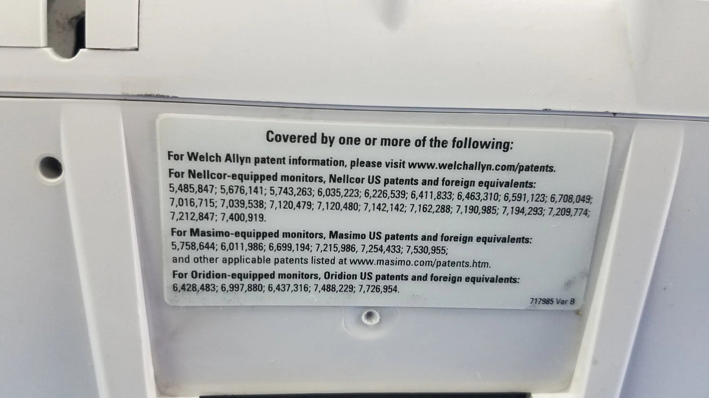 White rectangular patent information label with black text on the back of welch allyn vital signs monitor 6000 series with blood pressure cuffs
