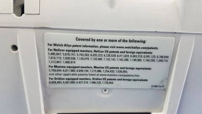 White rectangular patent information label with black text on the back of welch allyn vital signs monitor 6000 series with blood pressure cuffs