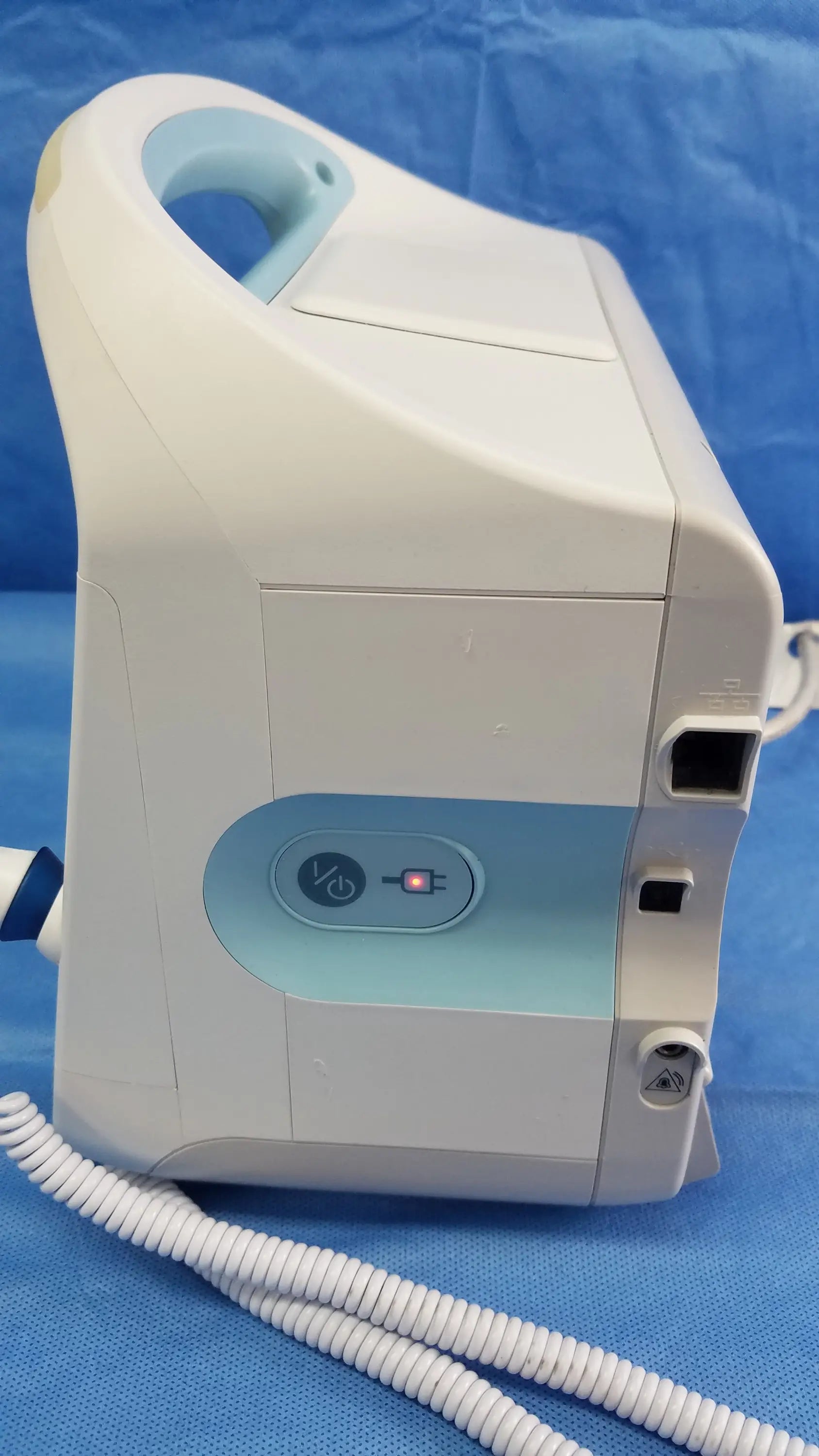 White and light blue welch allyn vital signs monitor 6000 series with handle, control panel, coiled tubing, and blood pressure cuffs
