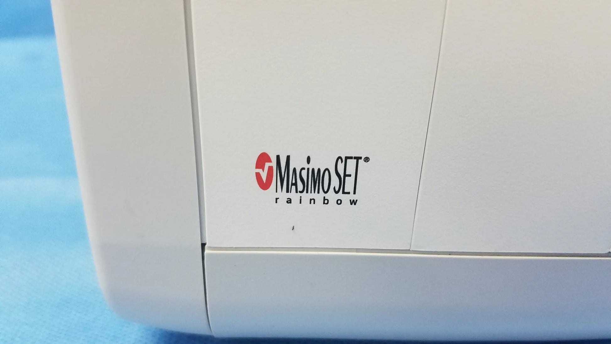 White masimo set rainbow medical vital signs monitor with blood pressure cuffs and red black logo on side for blood pressure