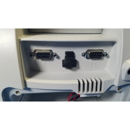 Back side of a white welch mismo set allyn spot vital signs patient monitor with two silver db-9 serial ports and vented panel
