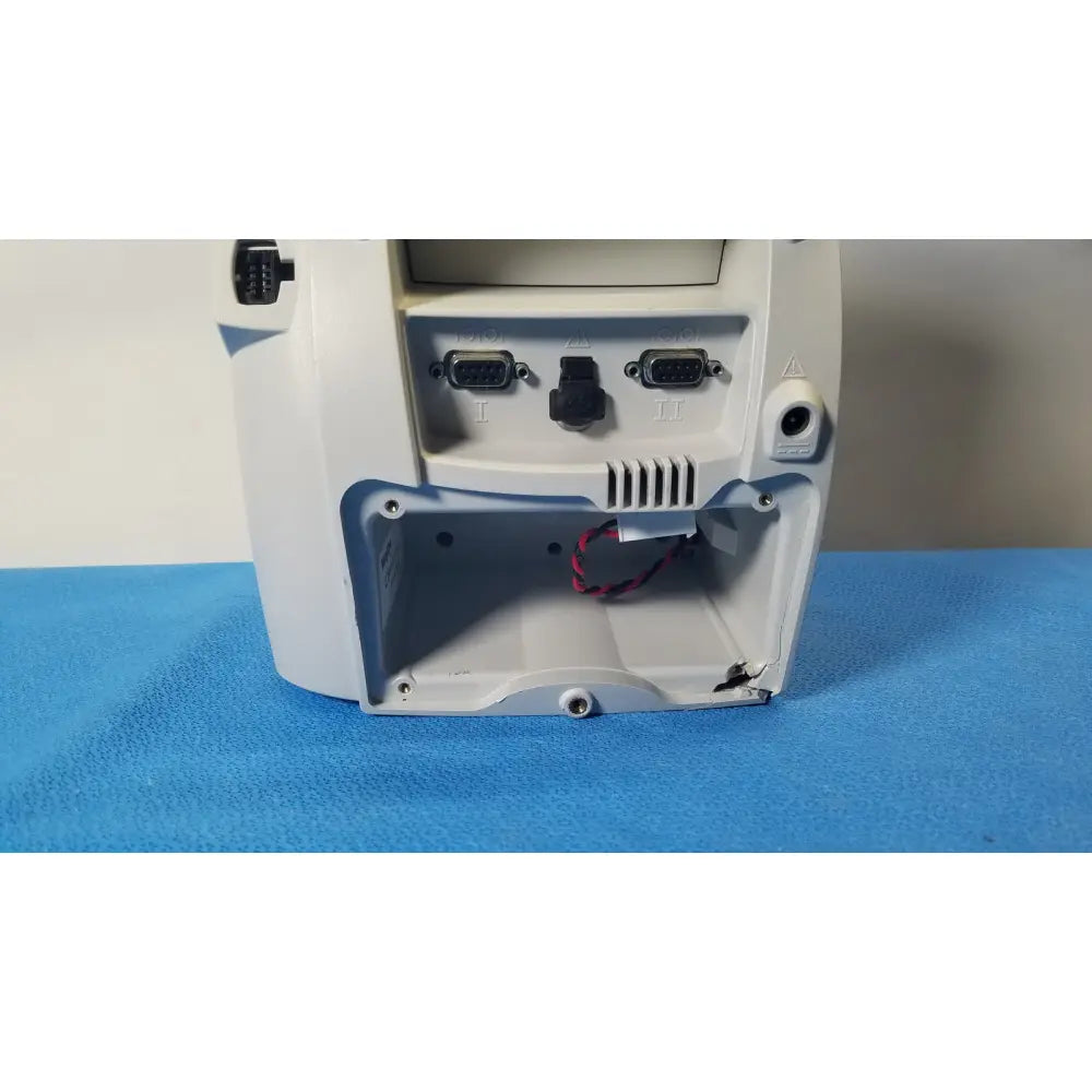 White plastic back side of welch mismo set allyn spot vital signs patient monitor with two db9 ports and open panel
