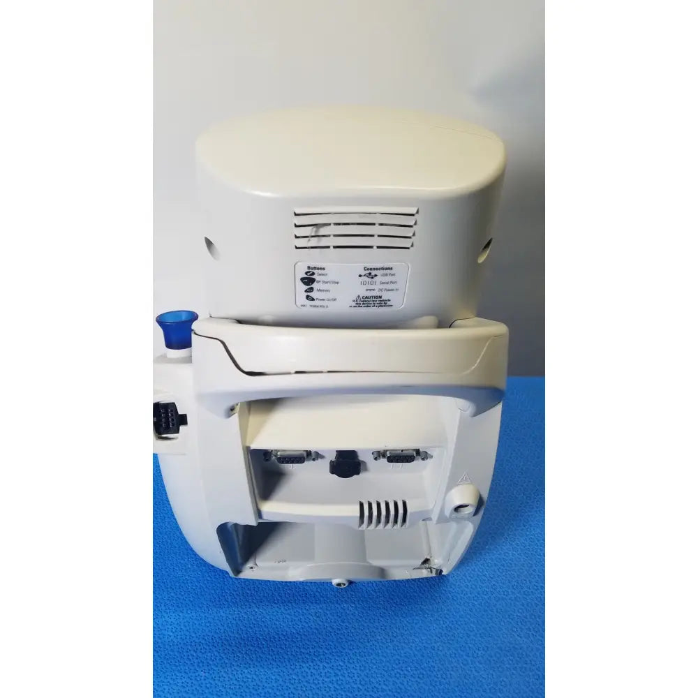 White plastic medical device with rounded top and multiple ports on back of welch mismo set allyn spot vital signs monitor