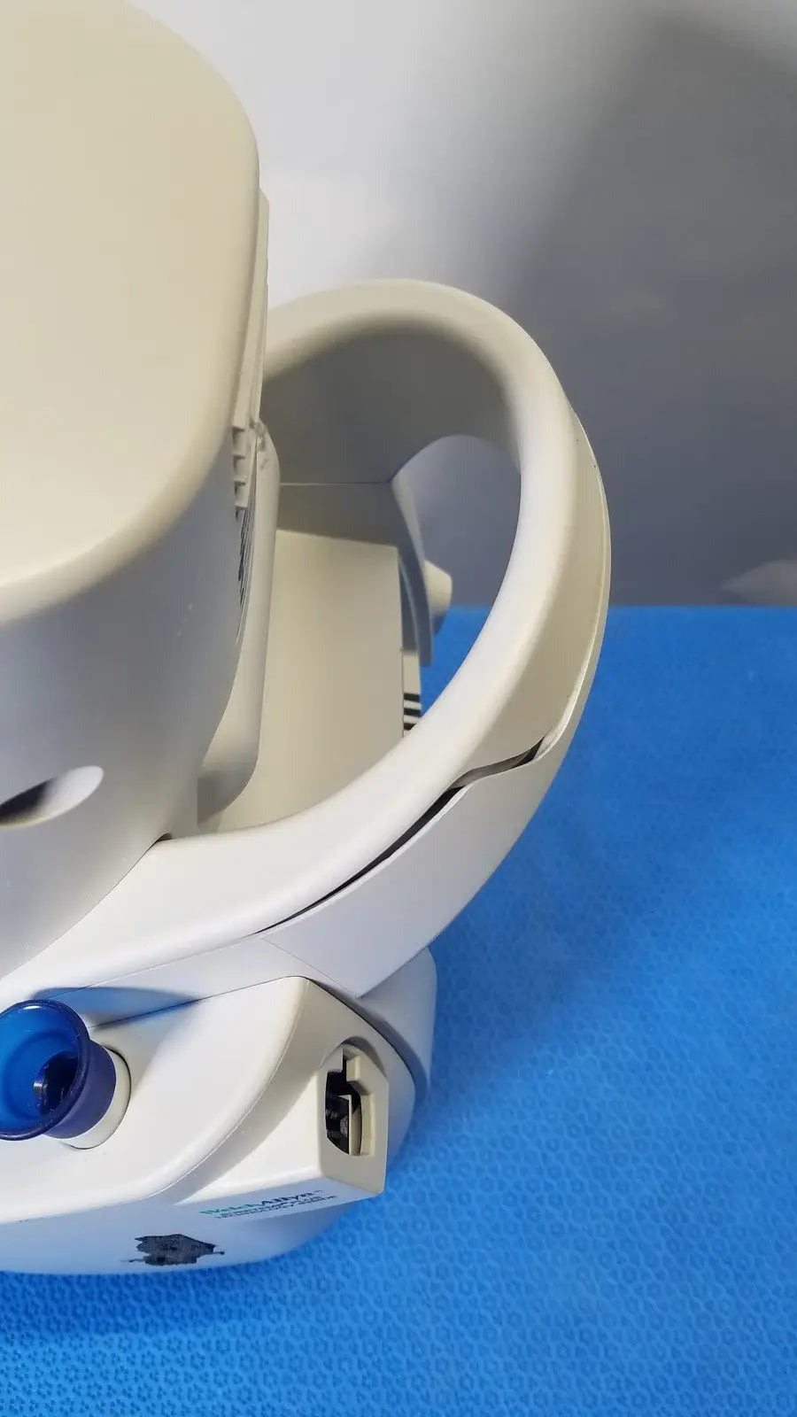 White plastic headgear with blue button and usb port featuring ergonomic design for medical use in mismo set allyn spot