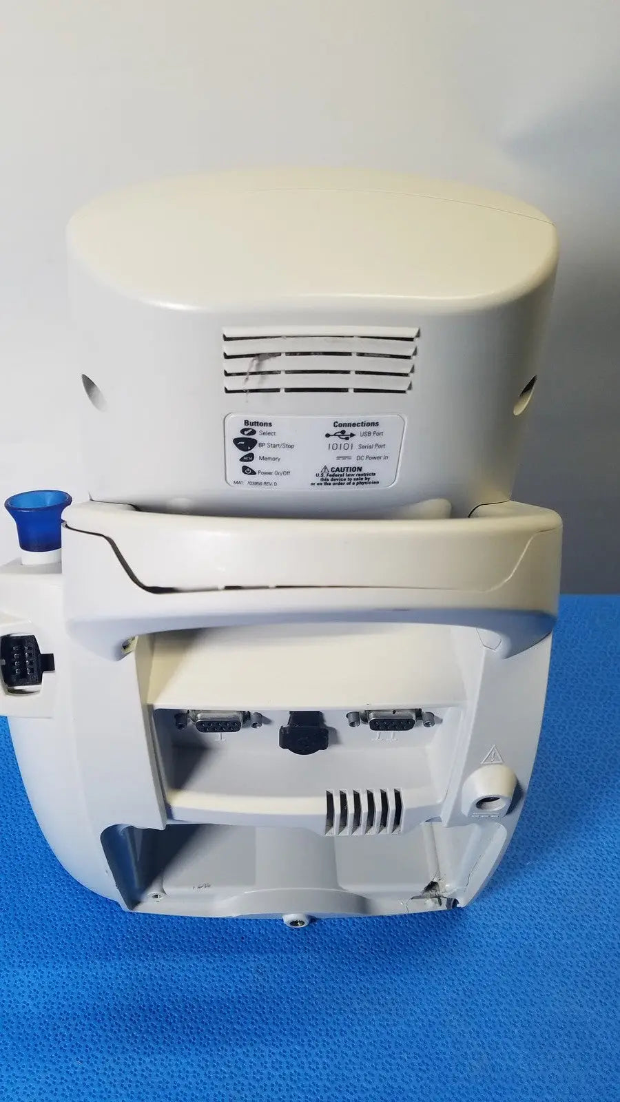 White plastic medical device with rounded top and multiple ports on back of welch mismo set allyn spot vital signs monitor