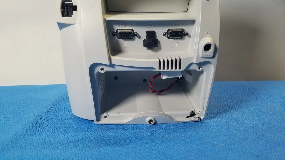 White plastic back side of welch mismo set allyn spot vital signs patient monitor with two db9 ports and open panel