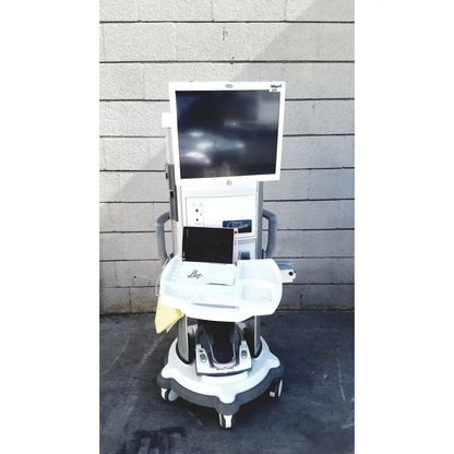 White medical cart with mounted monitor labeled migal on whitestar signature phacoemulsifier with footswitch