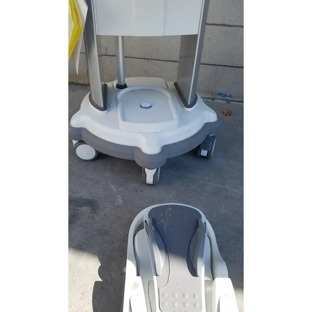 Gray and white plastic medical cart with four wheels for the whitestar signature phacoemulsifier with footswitch