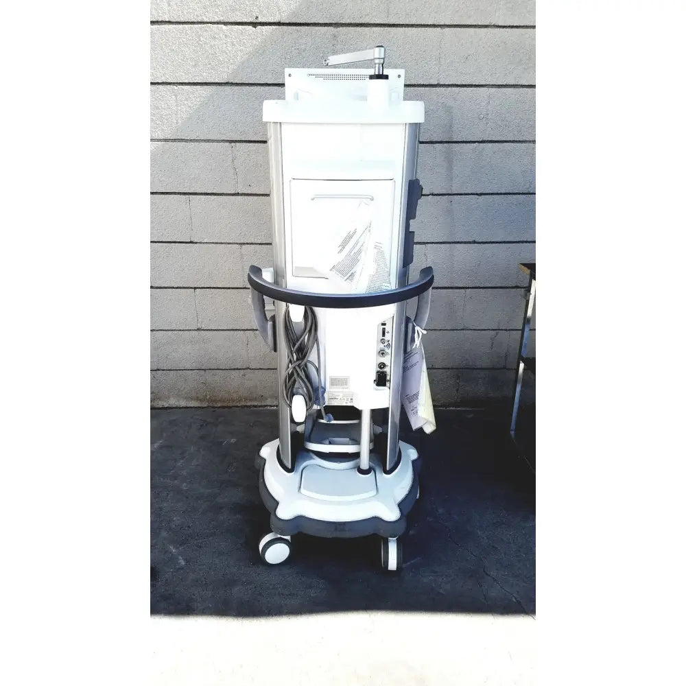 White and gray whitestar signature phacoemulsifier medical imaging machine on wheeled cart with footswitch for reuse medical use