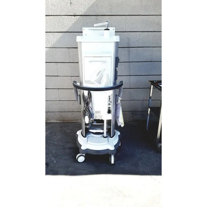 White and gray whitestar signature phacoemulsifier medical imaging machine on wheeled cart with footswitch