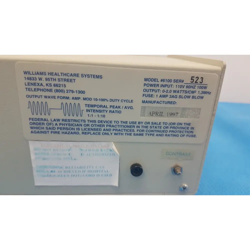 Beige williams 6100 ultrasound therapeutic device with black control knobs and detailed specification label for clinical use