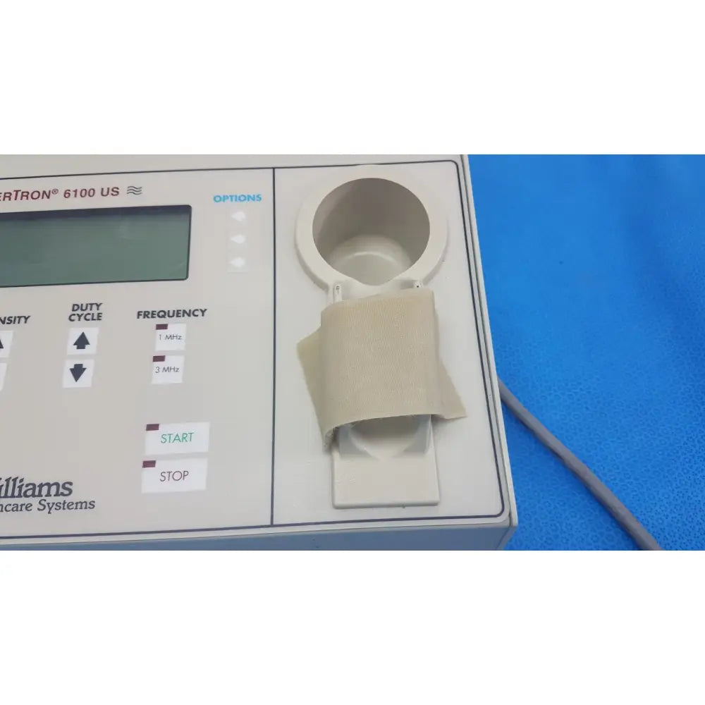 White williams 6100 ultrasound therapeutic device with beige adhesive band on circular port for clinical physical therapy