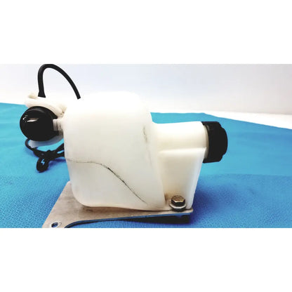 White plastic windshield washer fluid reservoir tank with black caps and metal mounting bracket for vehicle use