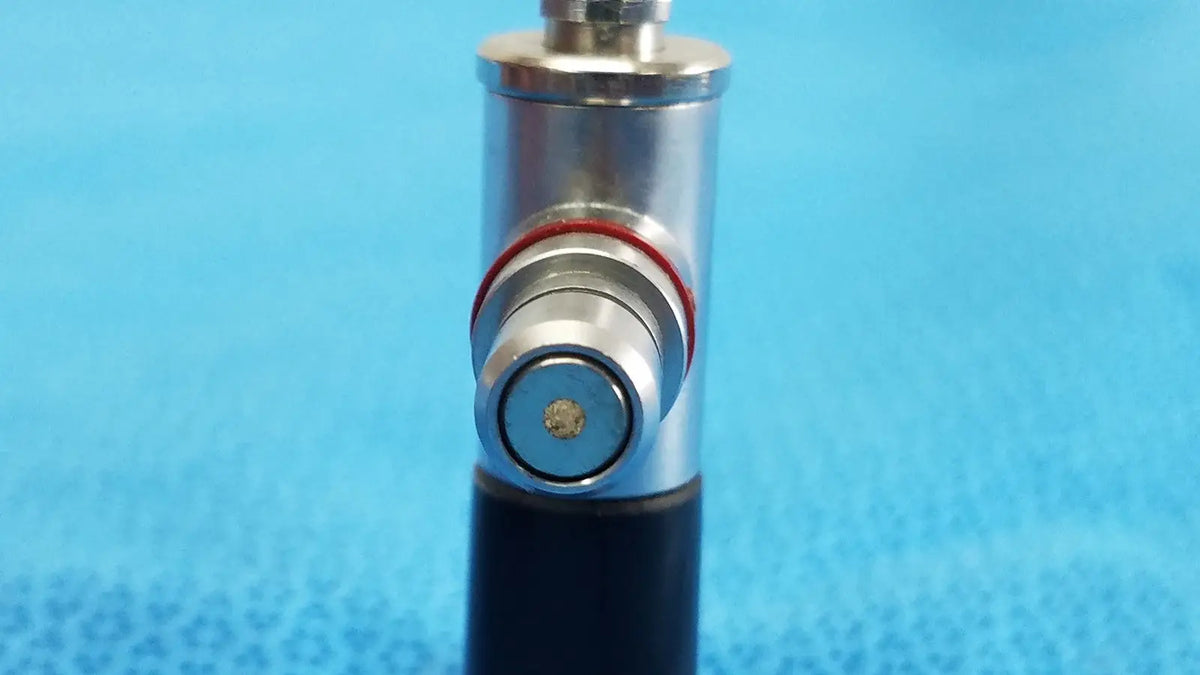 Silver metallic cylindrical arthroscopy endoscope orthopedic device wolf 8471.42 with black base and red rubber ring