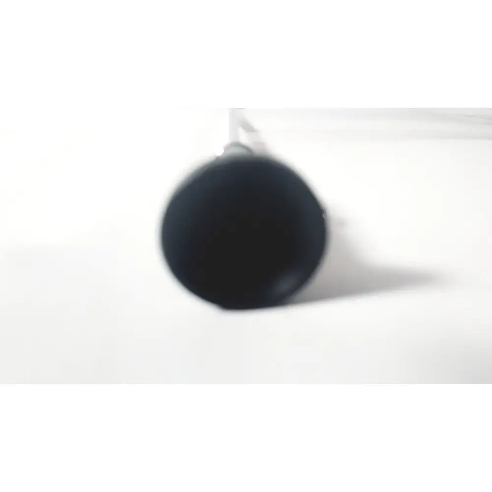 Black cylindrical mug with glossy finish hanging by handle shown with wolf 8853.42 25 degree rigid arthroscope product