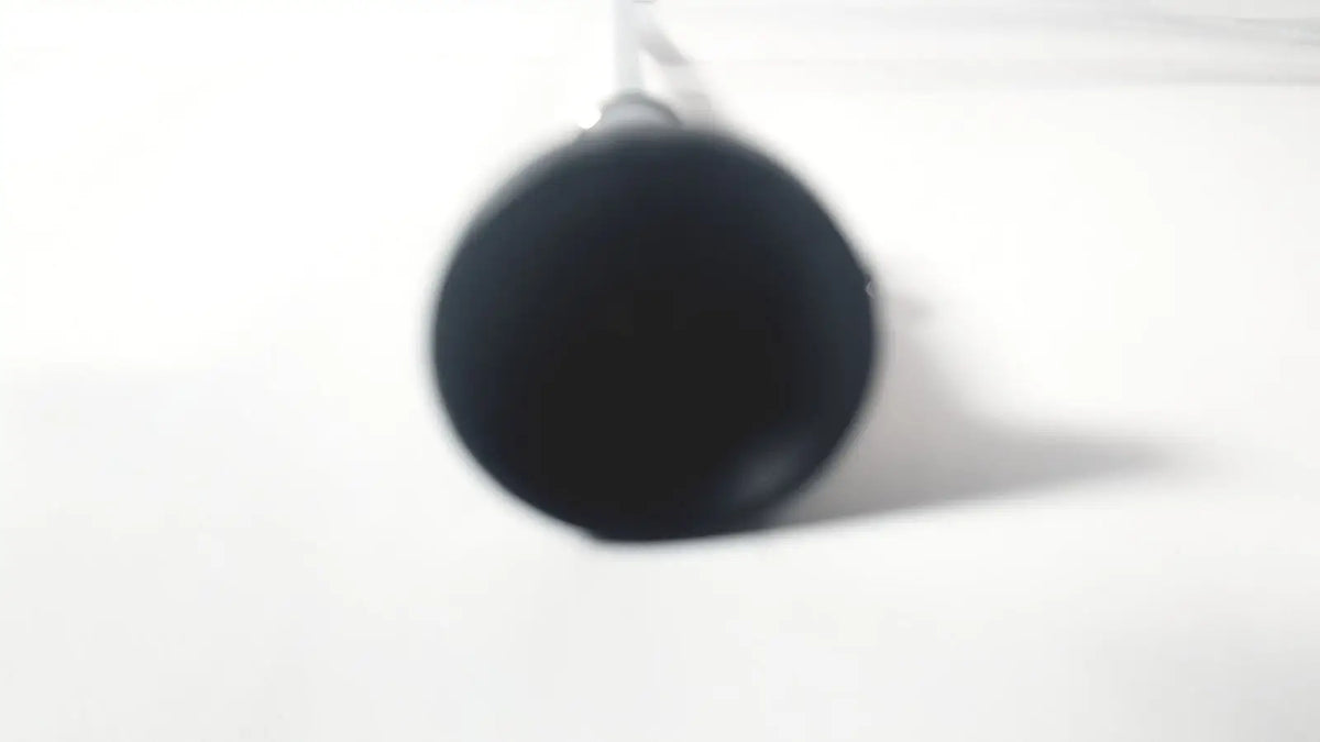 Black cylindrical mug with glossy finish hanging by handle shown with wolf 8853.42 25 degree rigid arthroscope product