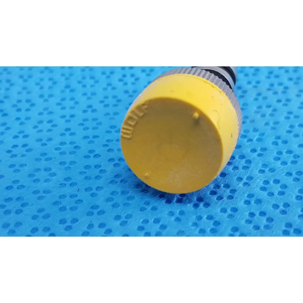 Yellow plastic nozzle with textured grip and embossed branding for wolf stainless luer-lock tube connector surgical fitting