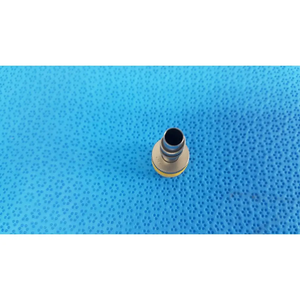 Yellow and metallic wolf stainless luer-lock tube connector with threaded end for surgical instrument fitting