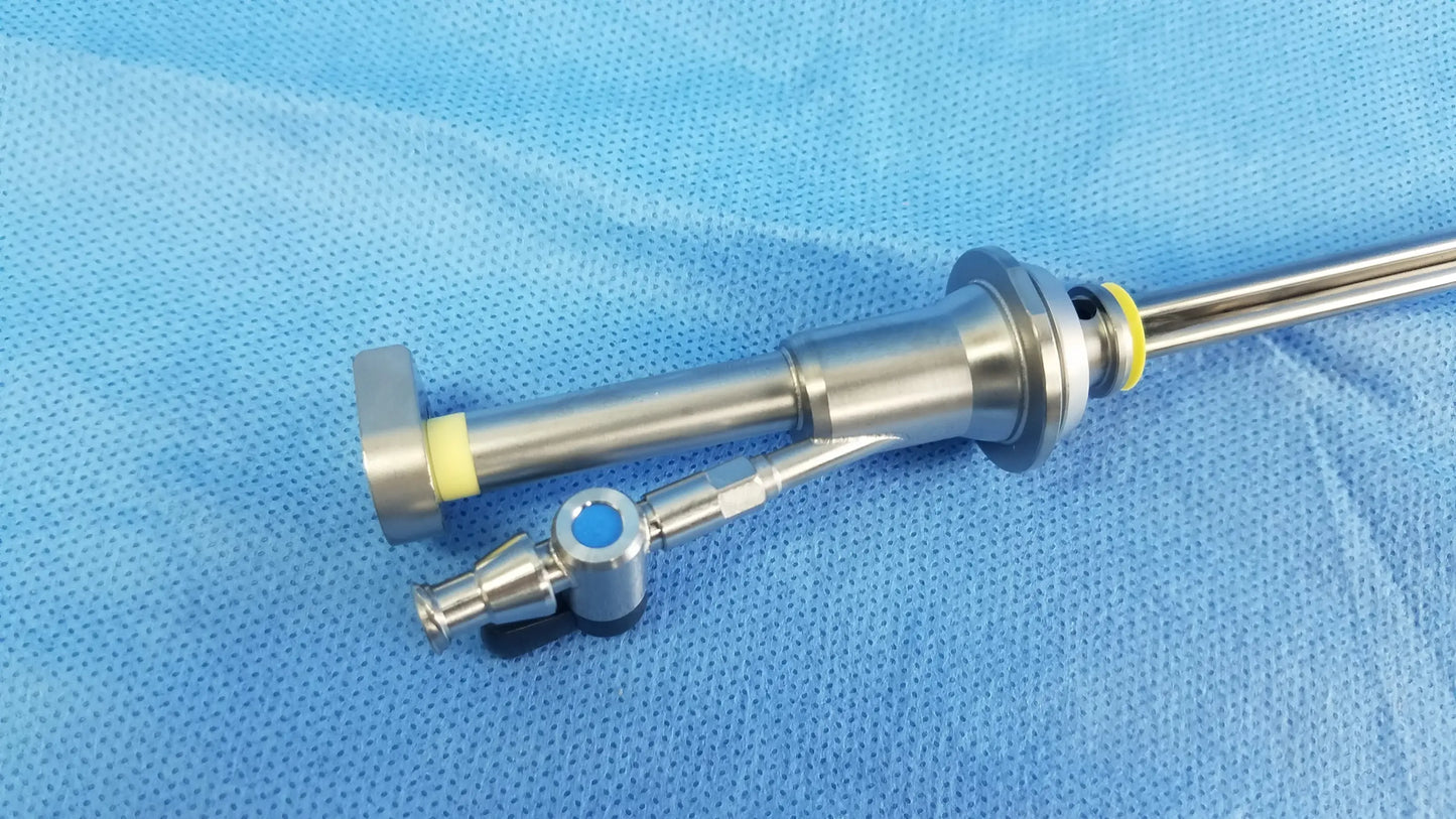 Working insert stainless steel endoscopic instrument with yellow rubber seal and blue lens housing in olympus sterilization tray