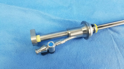Working insert stainless steel endoscopic instrument with yellow rubber seal and blue lens housing in olympus sterilization tray