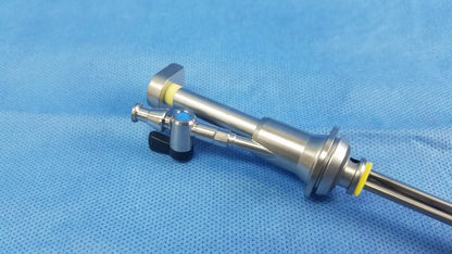 Silver working insert endoscopic instrument with yellow rubber seals and blue component in olympus sterilization tray