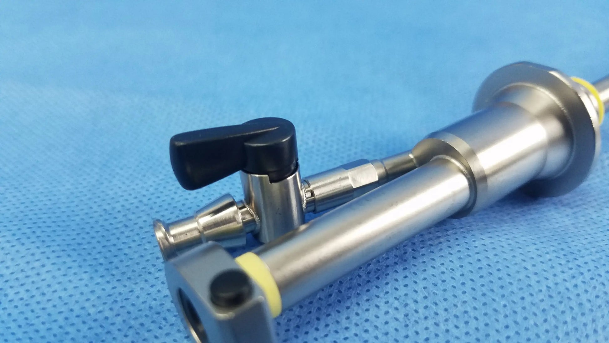 Silver working insert hystero-resectoscope with black handle and yellow accents in olympus sterilization tray endoscopic instrument