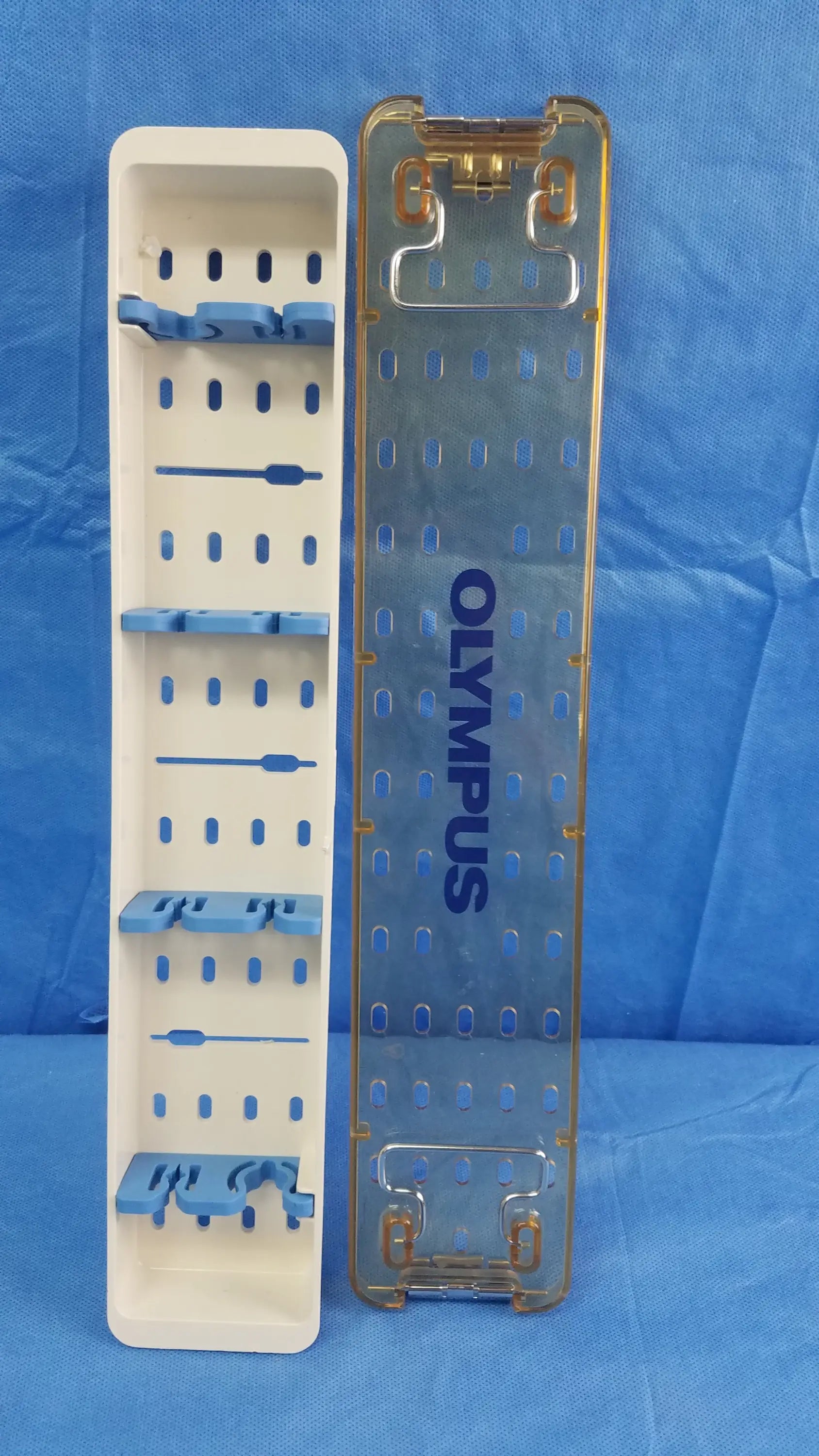 Transparent blue olympus sterilization tray with gold edges and slots for organizing endoscopic working insert tools