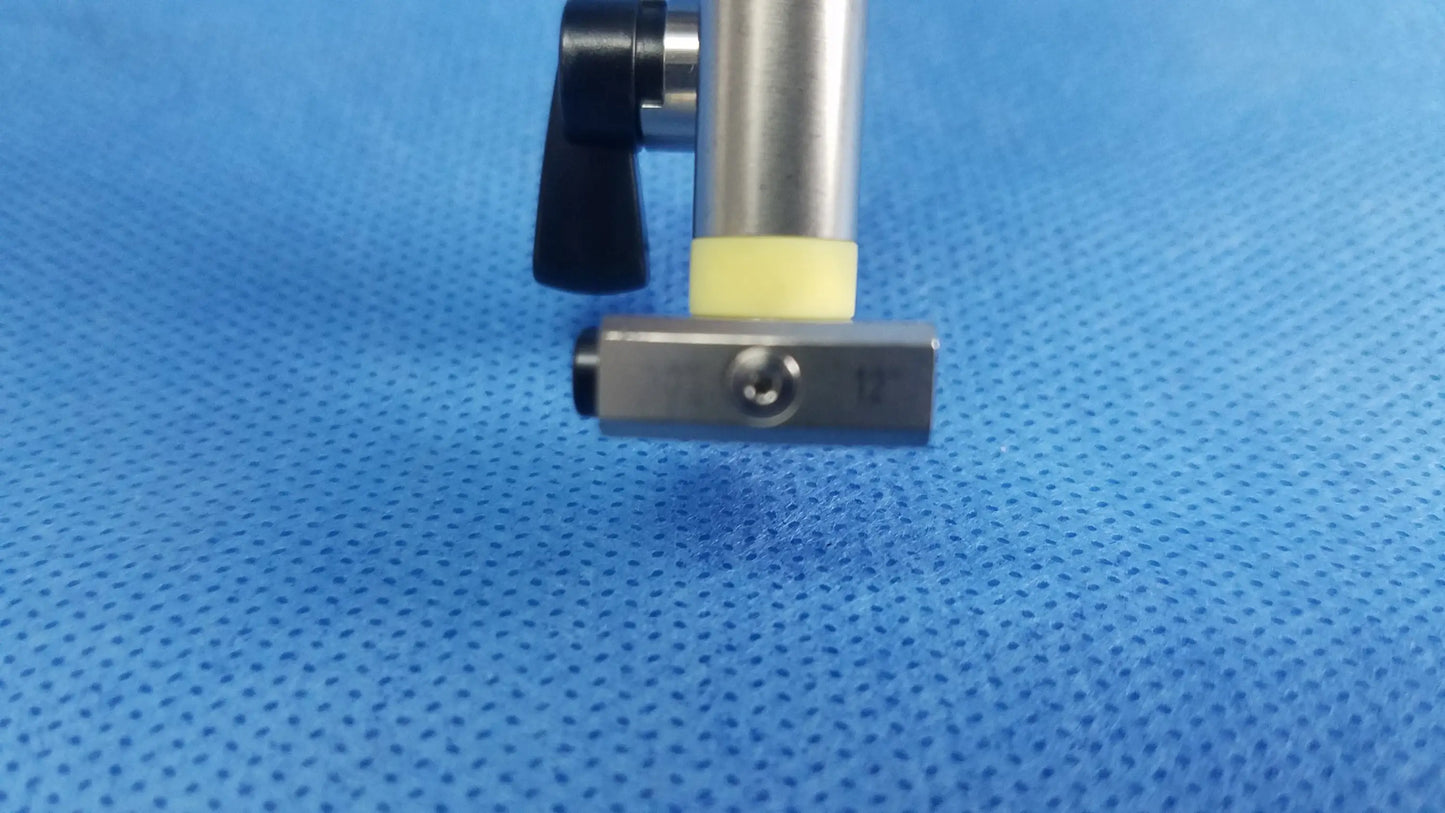 Working insert made of silver metallic caliper with black handle and yellow grip in olympus sterilization tray for endoscopic instrument use