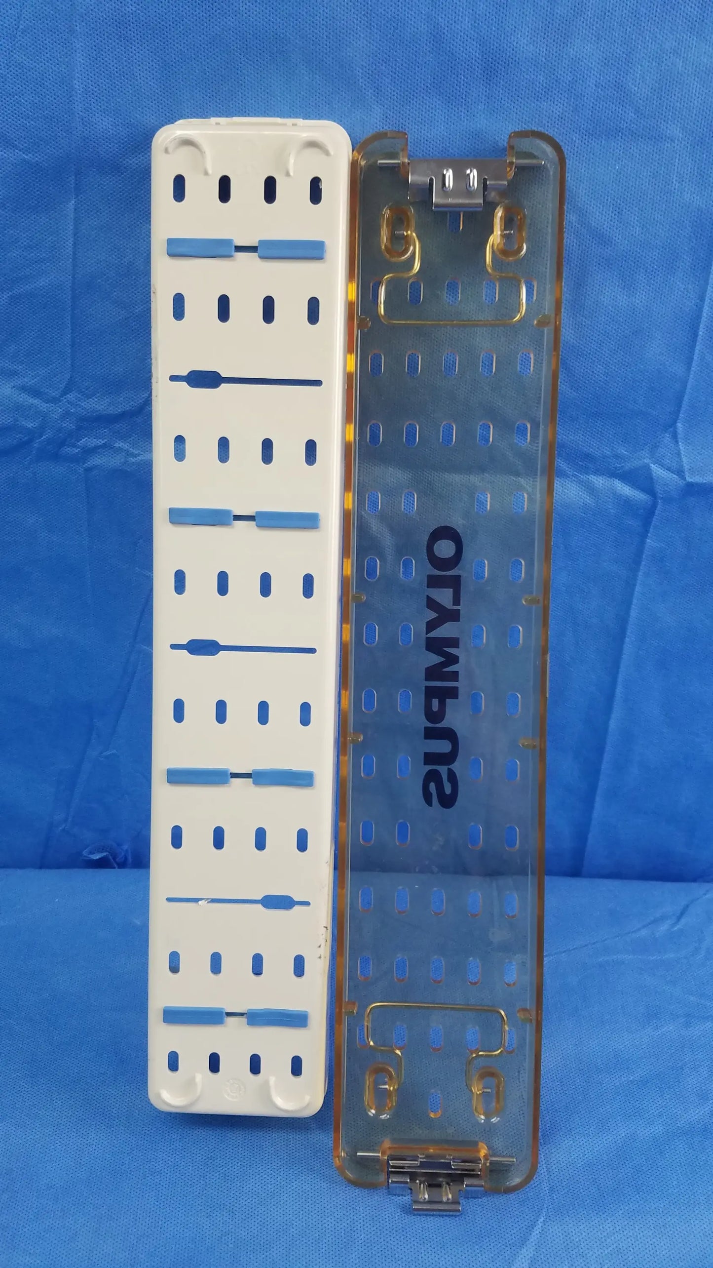 Working insert hystero-resectoscope with transparent and white plastic Olympus sterilization tray with blue accents for endoscopic instrument storage