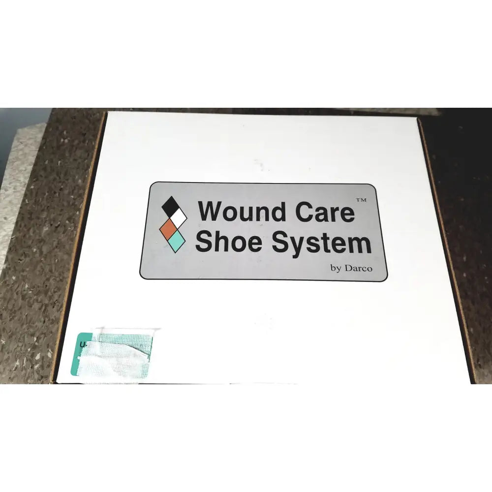 White cardboard wound care shoe system box by darco with gray logo featuring black, white, orange, and teal diamonds