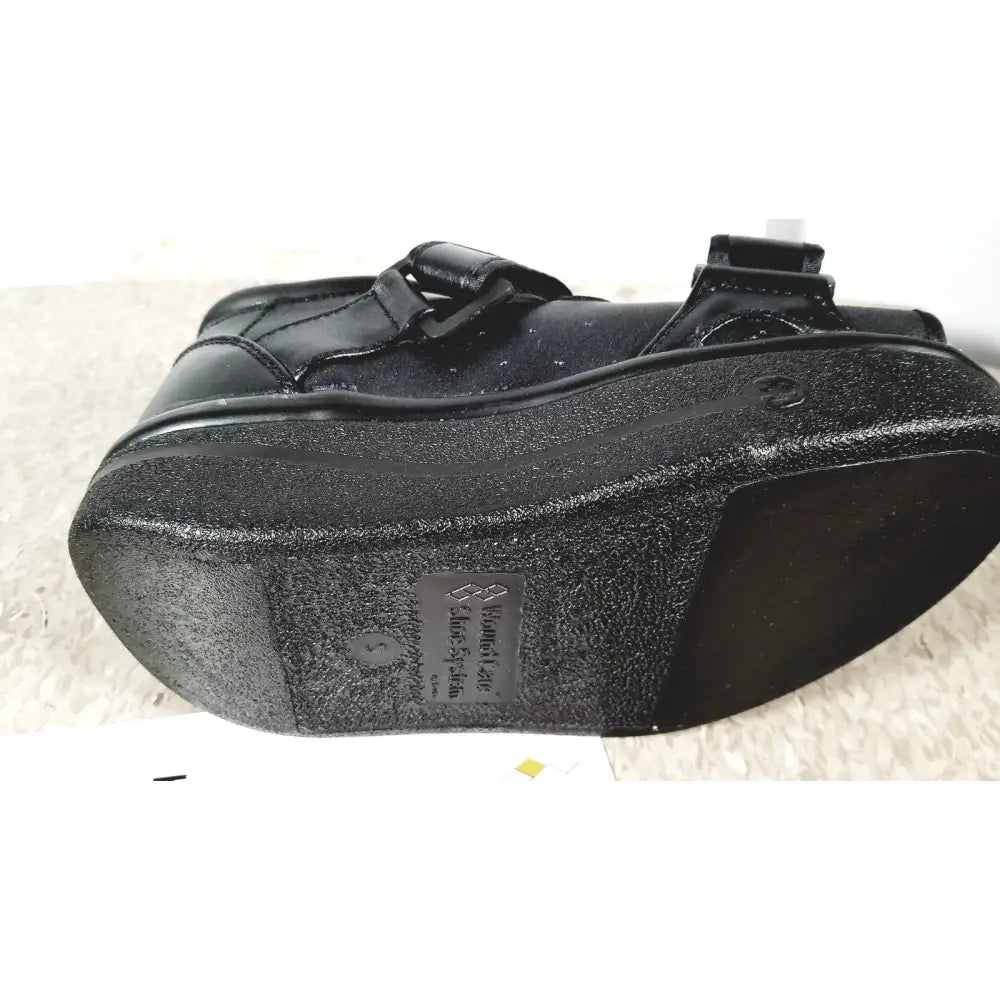 Black wound care shoe system small with textured rubber sole and adjustable strap closure for reuse medical use
