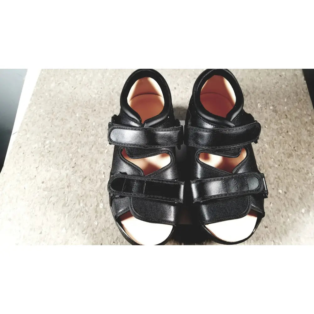 Black leather wound care shoe system small with two velcro straps and supportive design with light-colored insoles