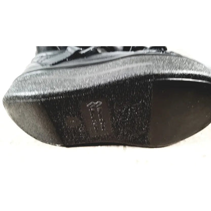 Small black textured sole with subtle sheen and embossed logo for wound care shoe system care shoe