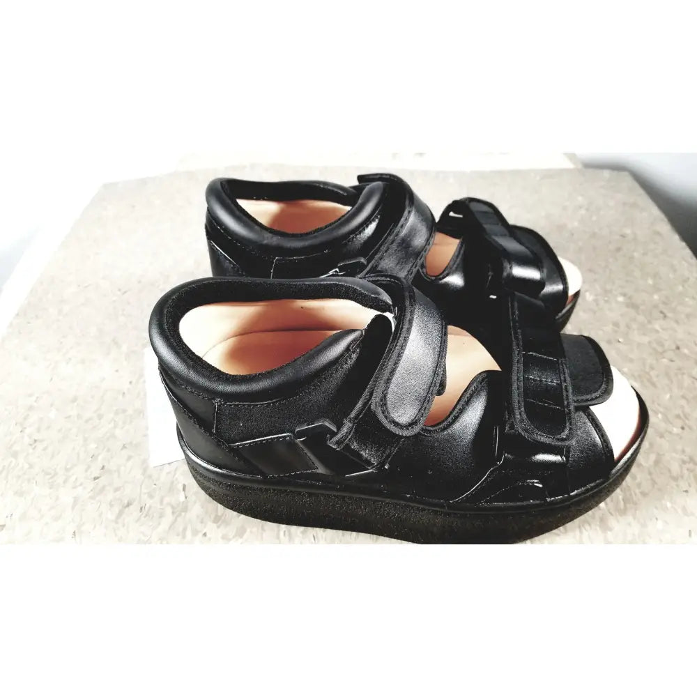 Black leather wound care shoe with adjustable velcro straps and thick supportive sole for small size care shoe system