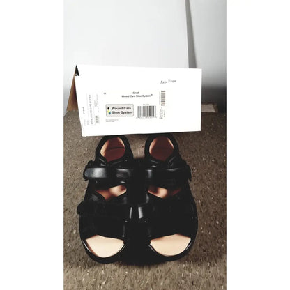 Black leather wound care shoe with adjustable straps and padded insole designed for small care shoe needs