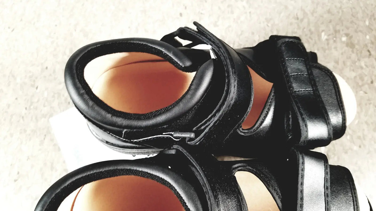 Black leather wound care shoe with thick straps and chunky sole designed for small size foot care shoes