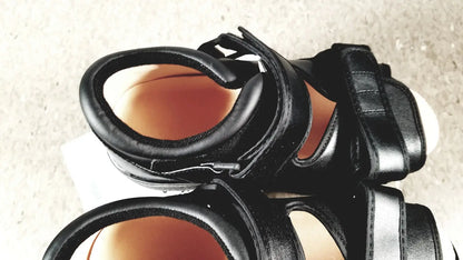Black leather wound care shoe with thick straps and chunky sole designed for small size foot care shoes
