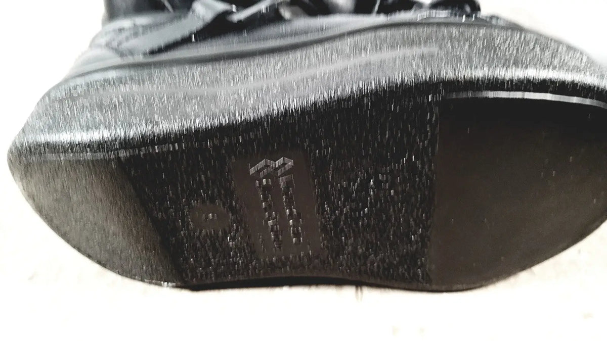 Small black textured sole with subtle sheen and embossed logo for wound care shoe system care shoe