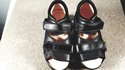 Black leather wound care shoe system small with two velcro straps and supportive design with light-colored insoles