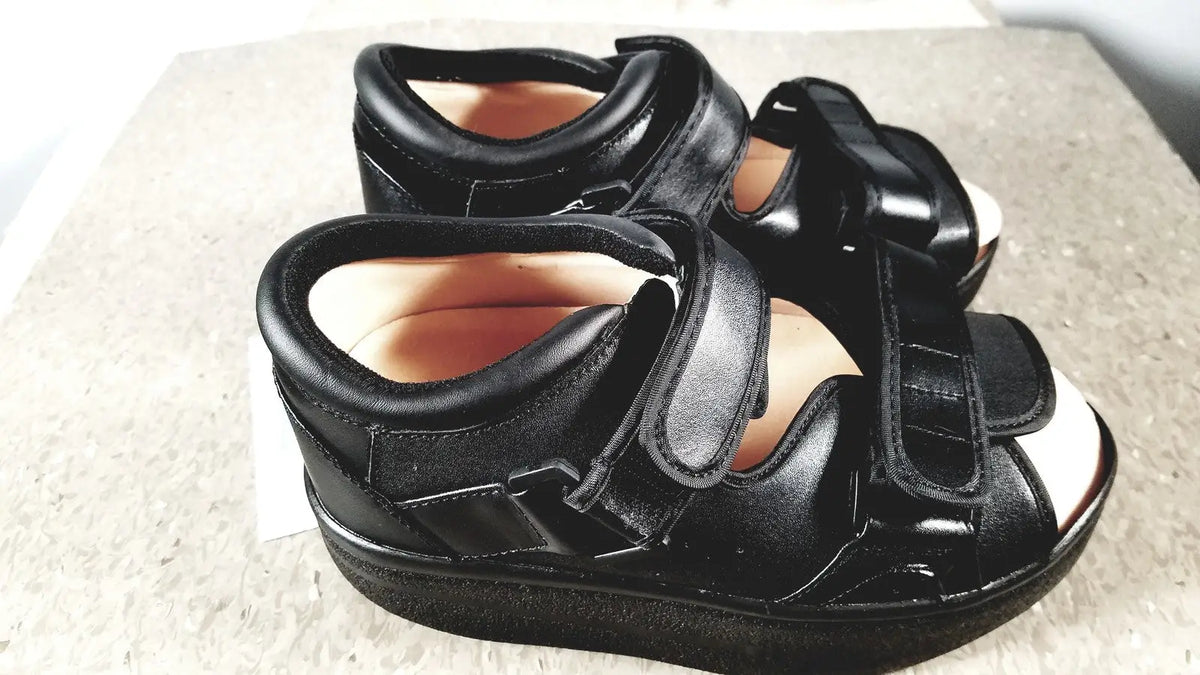 Black leather wound care shoe with adjustable velcro straps and thick supportive sole for small size care shoe system