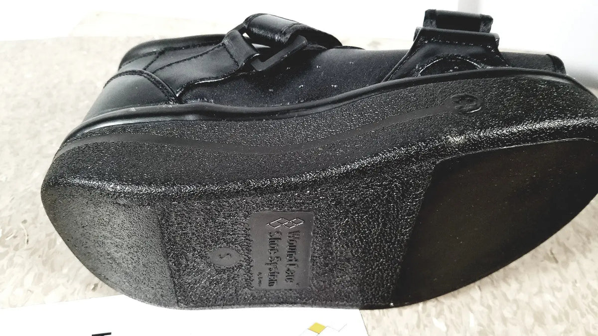 Black wound care shoe system small with textured rubber sole and adjustable strap closure for reuse medical use