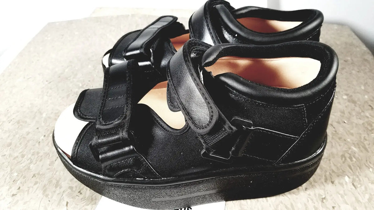 Black orthopedic wound care shoe small with thick platform sole and adjustable velcro straps for wound care