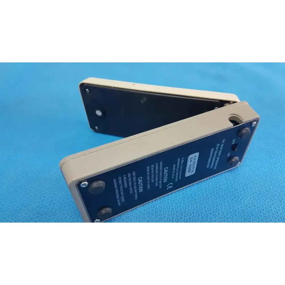 Beige and black x-rite 331 transmission densitometer with hinged design and labeled buttons battery operated medical equipment