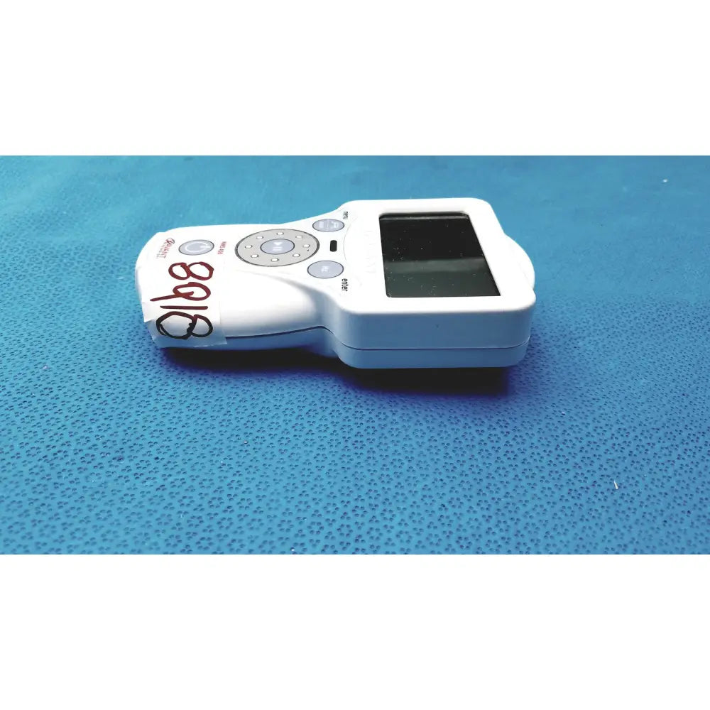 White handheld glucose meter with screen and button pad featuring handwritten label from xavant technology stimpod nms 450 transmission monitor