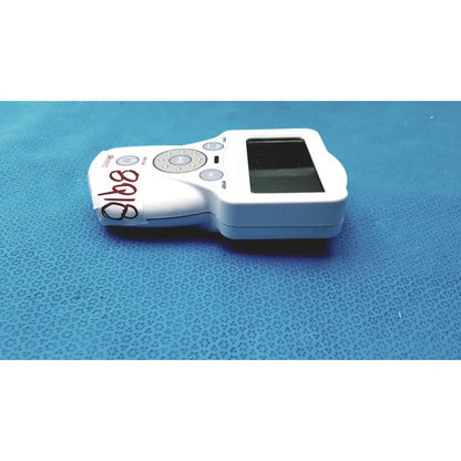 White handheld glucose meter with screen and button pad featuring handwritten label from xavant technology stimpod nms 450 transmission monitor