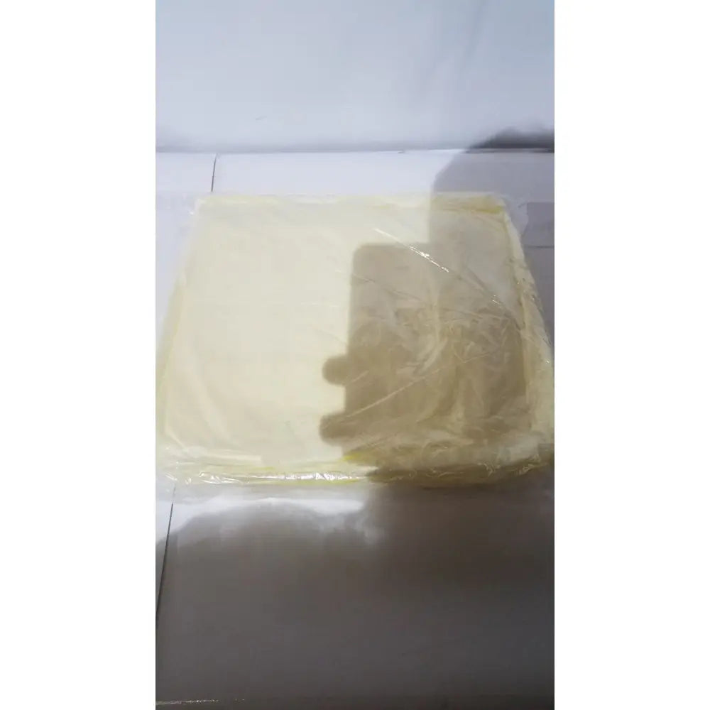 A translucent yellow plastic-wrapped rectangular block shown with xiantao 55-xl sms isolation gown packaging